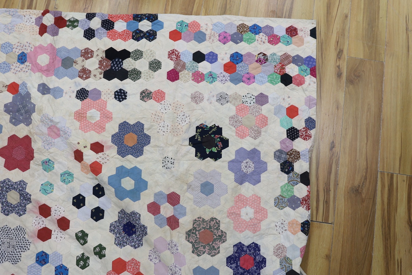 A patchwork quilt, made from Edwardian and later fabrics, 232 cms x 252cms.